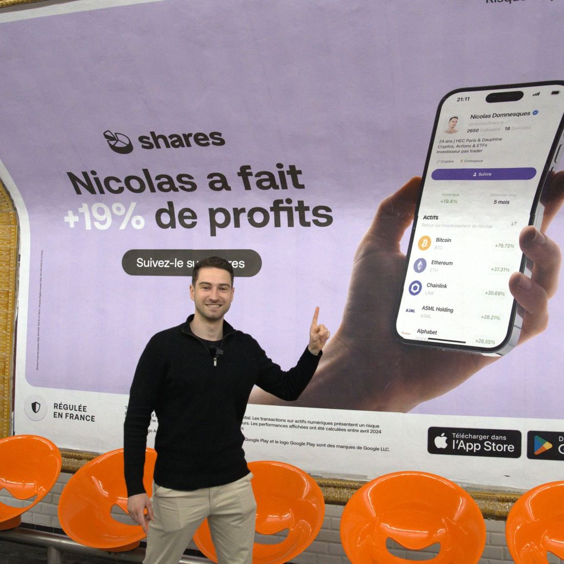 Nicolas in front of his own advertising billboard in the Paris metro